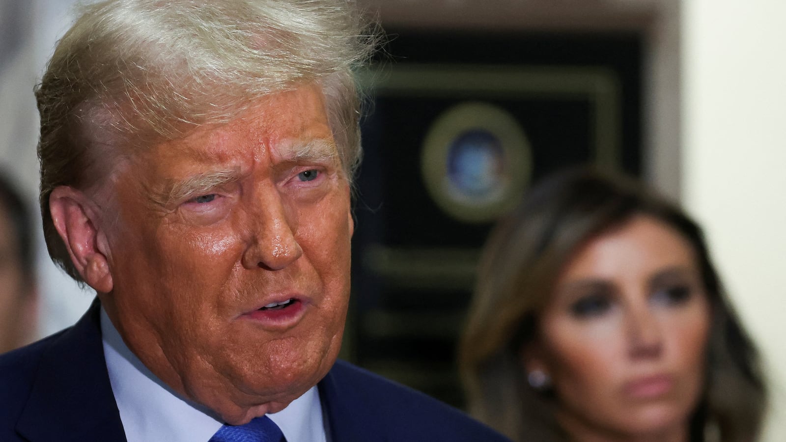 Donald trump has his mouth open as he leaves a courtroom in New York.