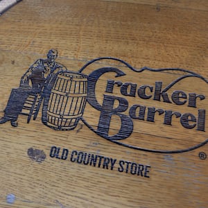 A Cracker Barrel sign featuring the old logo is seen outside of a restaurant on August 21, 2025 in Homestead, Florida.