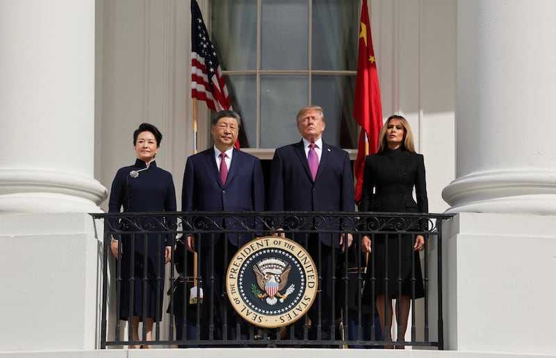 President Donald Trump, first lady Melania Trump, Chinese President Xi Jinping and his wife, Peng Liyuan watch a military demonstration from a balcony of the White House in Washington, D.C., September 24, 2026.