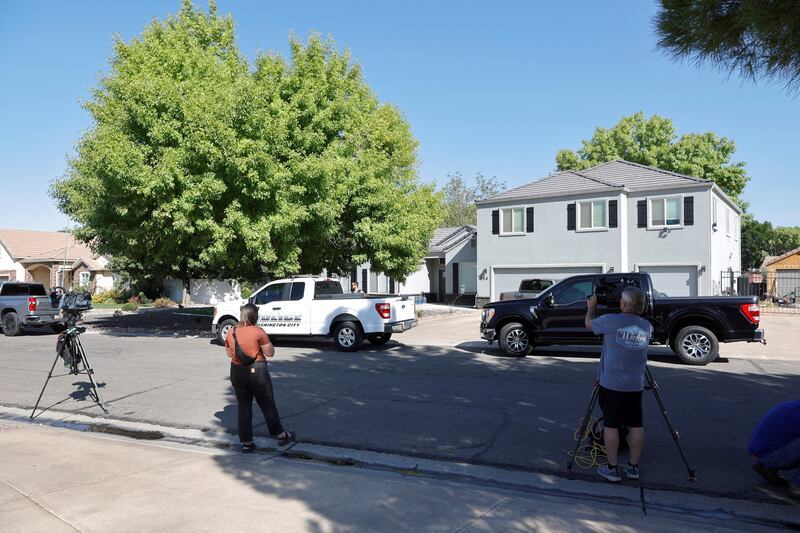 Reporters and photographers are shown at a residence in Washington, Utah, associated with Tyler Robinson, the suspect in the fatal shooting of U.S. conservative commentator Charlie Kirk during an event at Utah Valley University, Sept. 12, 2025.
