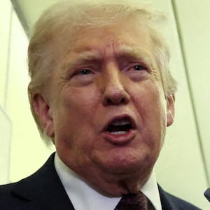 U.S. President Donald Trump speaks to reporters aboard Air Force One on a flight back to Washington March 15, 2026. REUTERS/Kevin Lamarque     TPX IMAGES OF THE DAY