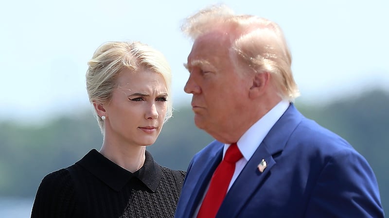 DOVER, DELAWARE - JULY 22: Natalie Harp, executive assistant to U.S. President Donald Trump, stands as President Trump arrives for a dignified transfer at Dover Air Force Base for military casualties of the war with Iran on July 22, 2026 in Dover, Delaware. Trump attend the dignified transfer of of Army 1st Lt. Tyler James Feehan, Staff Sgt. Michael Emmanuel Swinton, Army Sgt. Angel S. Rampersad and Army Pvt. Isabella Gonzales. (Photo by Kevin Dietsch/Getty Images)