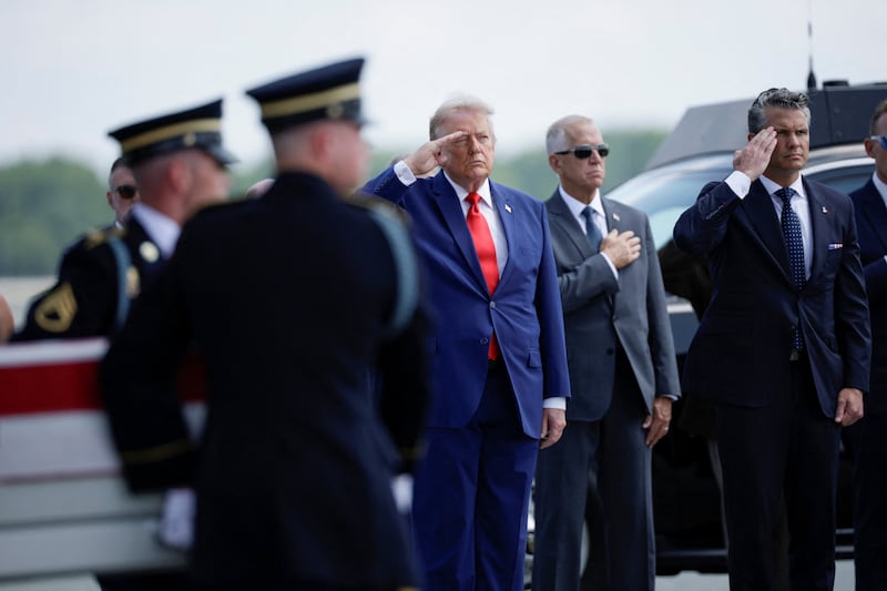 U.S. President Donald Trump and U.S. Secretary of Defense Pete Hegseth salute as members of the military carry the transfer case of U.S. Army Sgt. Michael Emmanuel Swinton of D Battery, 2nd Battalion, 55th Air Defense Artillery Regiment, 108th Air Defense Artillery Brigade, who was killed in action during a controlled detonation of a downed one-way unmanned aerial system at Erbil Air Base in Iraq, during a dignified transfer of his remains at Dover Air Force Base in Dover, Delaware, U.S., July 22, 2026. REUTERS/Evan Vucci