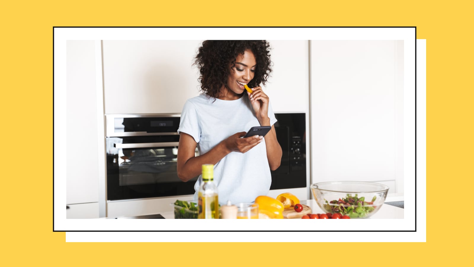 Woman eating food while checking her phone.