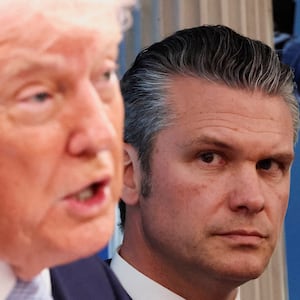 U.S. Secretary of Defense Pete Hegseth looks at U.S. President Donald Trump as he holds a press conference in the James S. Brady Press Briefing Room at the White House in Washington, D.C., U.S., April 6, 2026. REUTERS/Kevin Lamarque      TPX IMAGES OF THE DAY