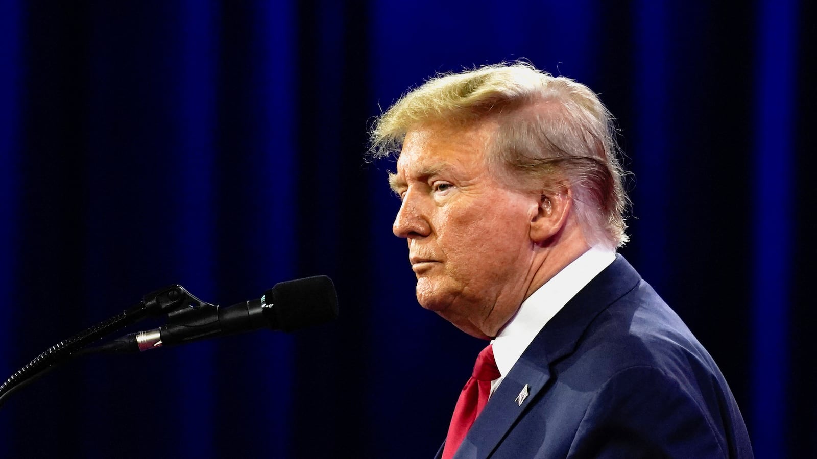 Side-profile view of Donald Trump staring forward at a campaign event.