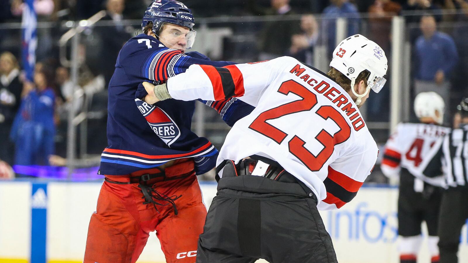 New York Rangers center Matt Rempe (73) and New Jersey Devils defenseman Kurtis MacDermid (23) fight at the start of the first period at Madison Square Garden.