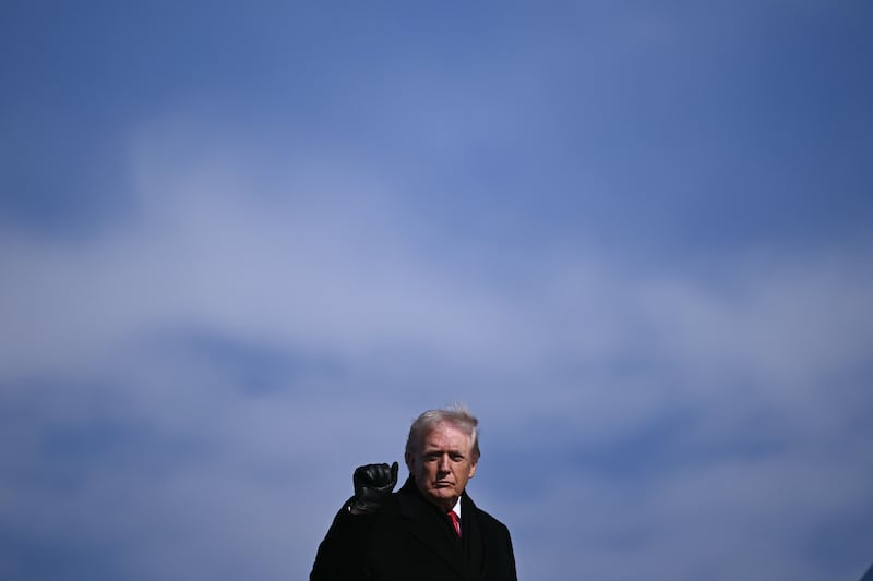 President Donald Trump gestures as he boards Air Force One at Joint Base Andrews, Maryland on January 27, 2026.