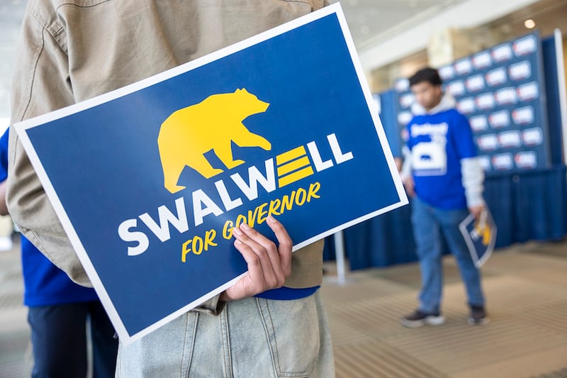 A supporter for Eric Swalwell holds a campaign sign at the California Democratic Party State Convention held at the Moscone Center  on Friday, Feb. 20, 2026 in San Francisco, CA. Swalwell is running for California Governor.