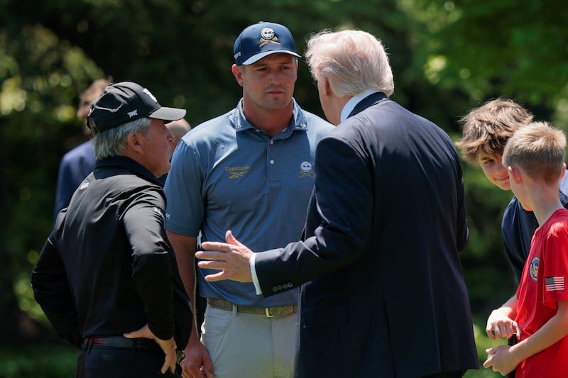 U.S. President Donald Trump speaks with professional golfer Bryson DeChambeau and retired professional golfer Gary Player during an event held for National Youth Sports and Fitness Month, on the South Lawn of the White House in Washington, D.C., U.S., May 5, 2026. REUTERS/Evan Vucci