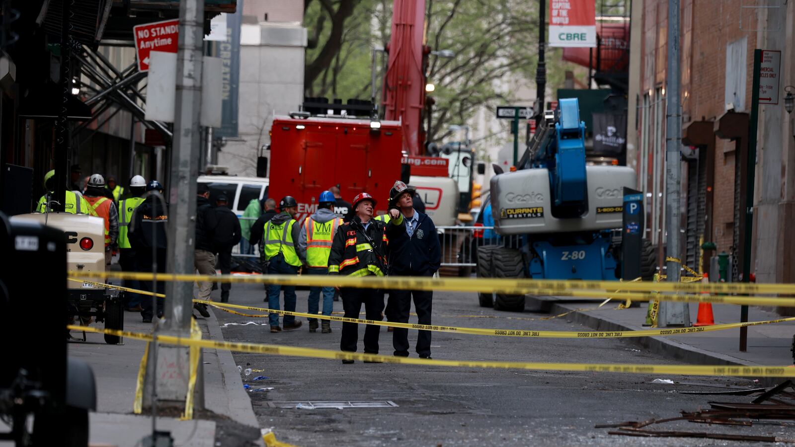 FDNY and Buildings Department officials are pictured near the scene of the Parking garage collapse