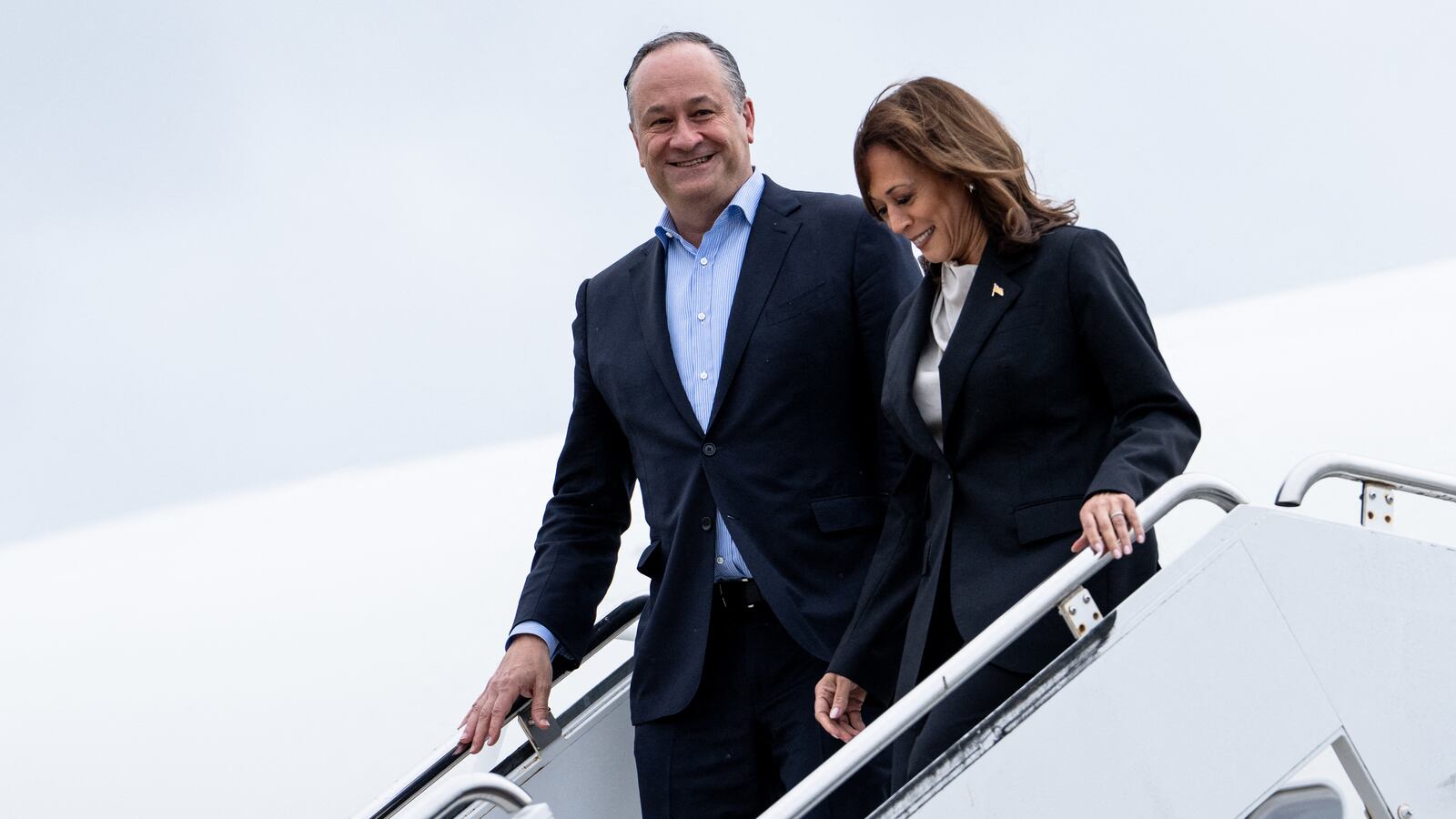 U.S. Vice President Kamala Harris and second gentleman Douglas Emhoff descend from Air Force Two at Delaware National Air Guard base in New Castle, Delaware, on July 22, 2024.