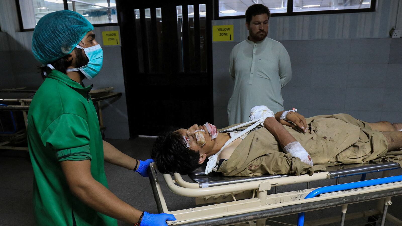 Paramedical staff wheels a man who was injured after a blast in the Bajaur district of Khyber Pakhtunkhwa, at the Lady Reading Hospital in Peshawar, Pakistan, July 30, 2023.