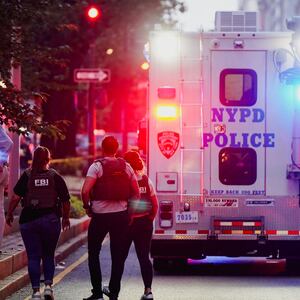 FBI agents investigate near a NYPD response vehicle near the scene of a reported shooter situation in Manhattan on July 28, 2025.