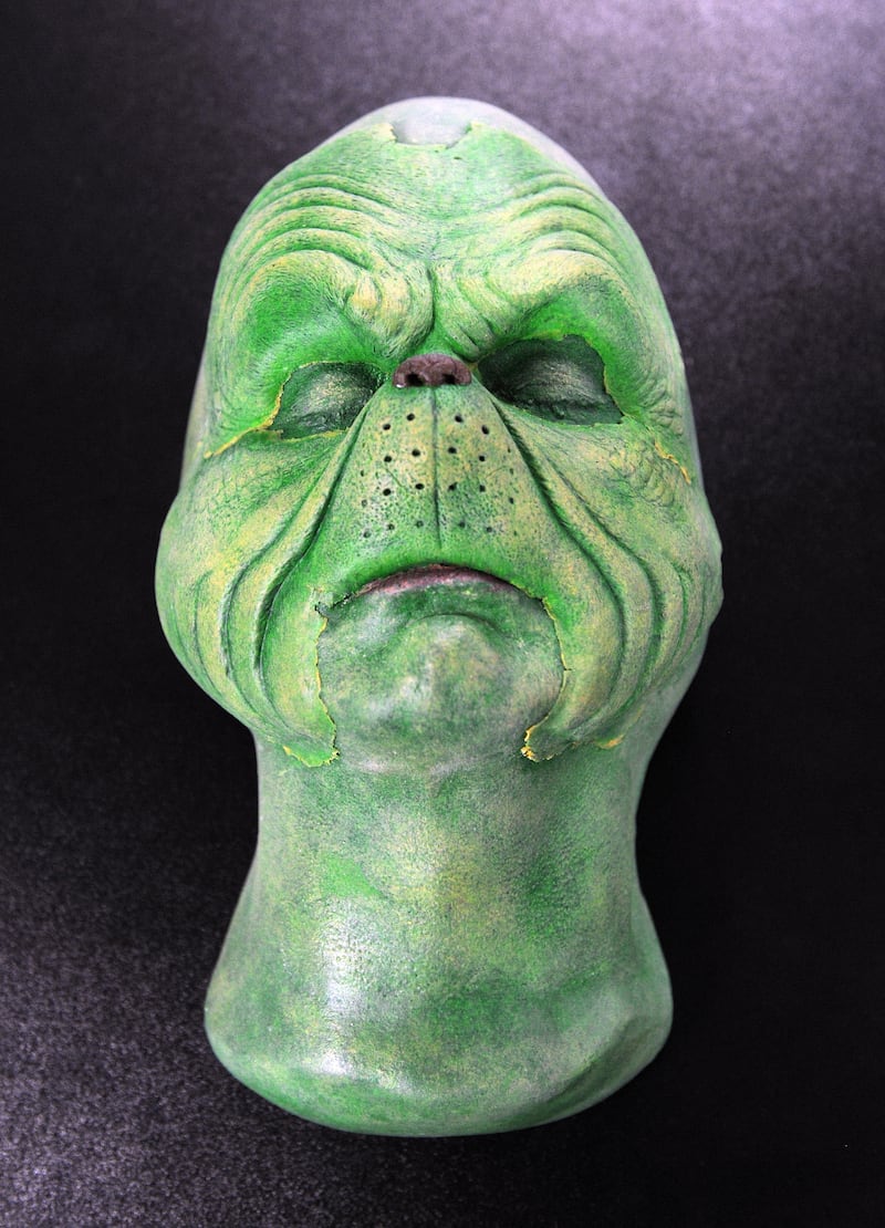 A make-up face cast from the Jim Carrey movie "How the Grinch Stole Christmas" is displayed with other movie memorabilia at the Heritage Auction Gallery in Beverly Hills on April 8, 2010. AFP PHOTO/Mark RALSTON