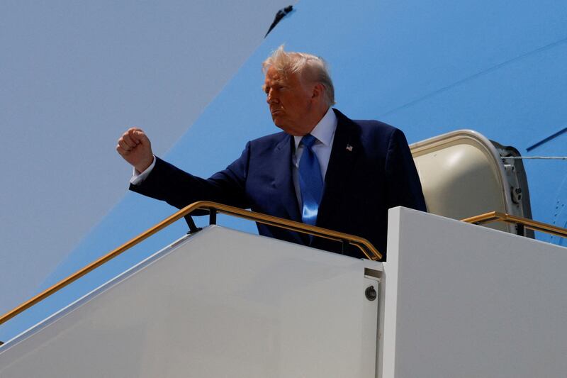 U.S. President Donald Trump gestures while he boards Air Force One in Abu Dhabi