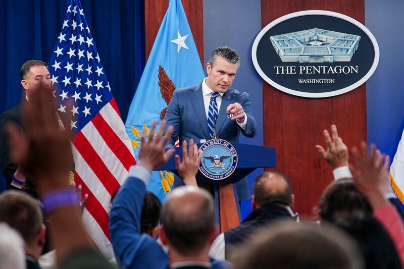 Reporters raise their hands to ask questions during a briefing on the Iran war with U.S. Secretary of Defense Pete Hegseth and Chairman of the Joint Chiefs of Staff General Dan Caine (not pictured), at the Pentagon in Washington, D.C., U.S., April 16, 2026. REUTERS/Nathan Howard