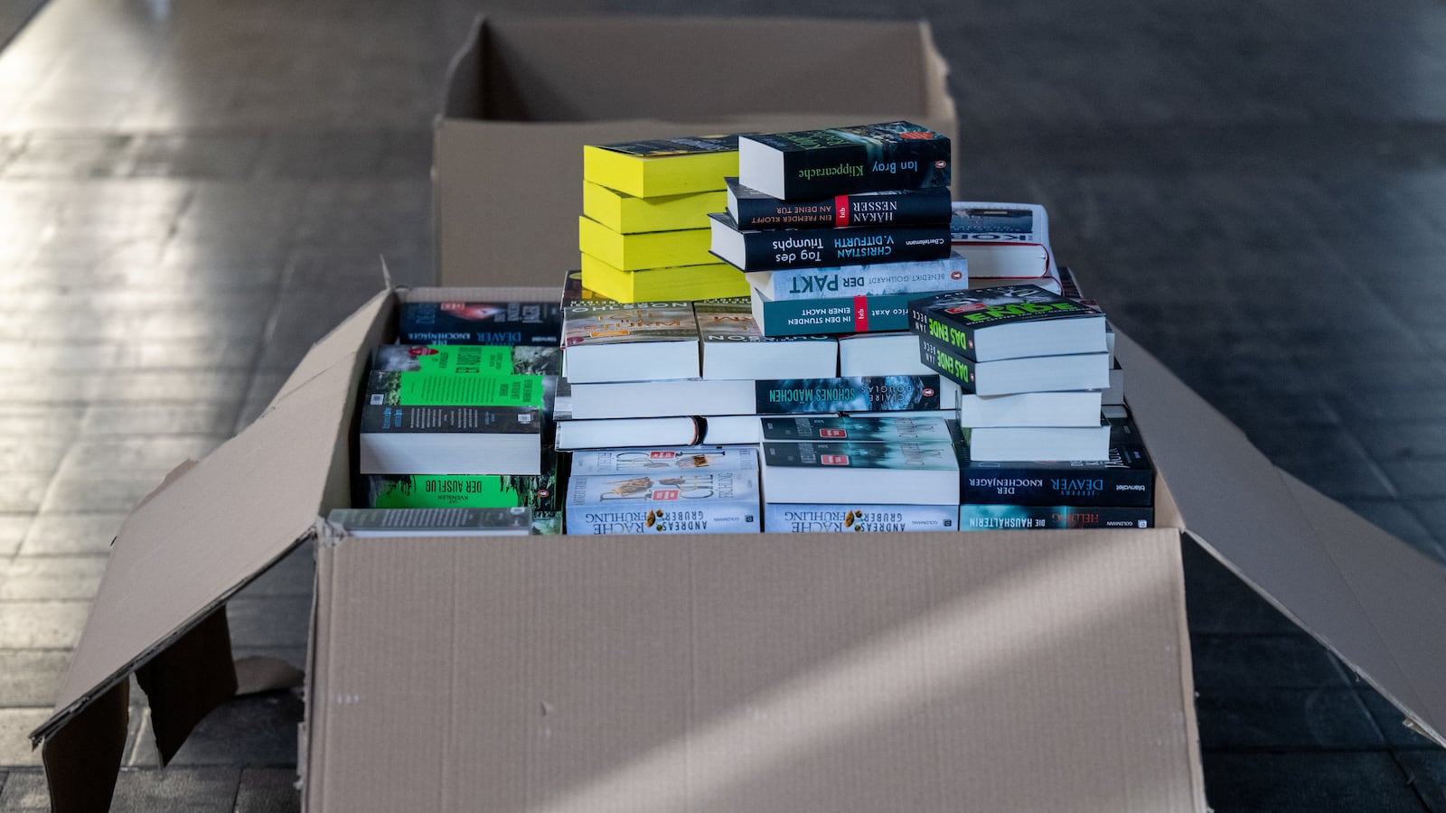 20 March 2024, Saxony, Leipzig: A box of books stands at the Penguin Random House stand at the Leipzig Book Fair. From Thursday (March 21) to Sunday, over 2000 exhibitors from 40 countries presented their new products at the spring meeting of the book industry. Under the motto "Everything but flat", the Netherlands and Flanders are represented as guest countries this year. Photo: Hendrik Schmidt/dpa (Photo by Hendrik Schmidt/picture alliance via Getty Images)