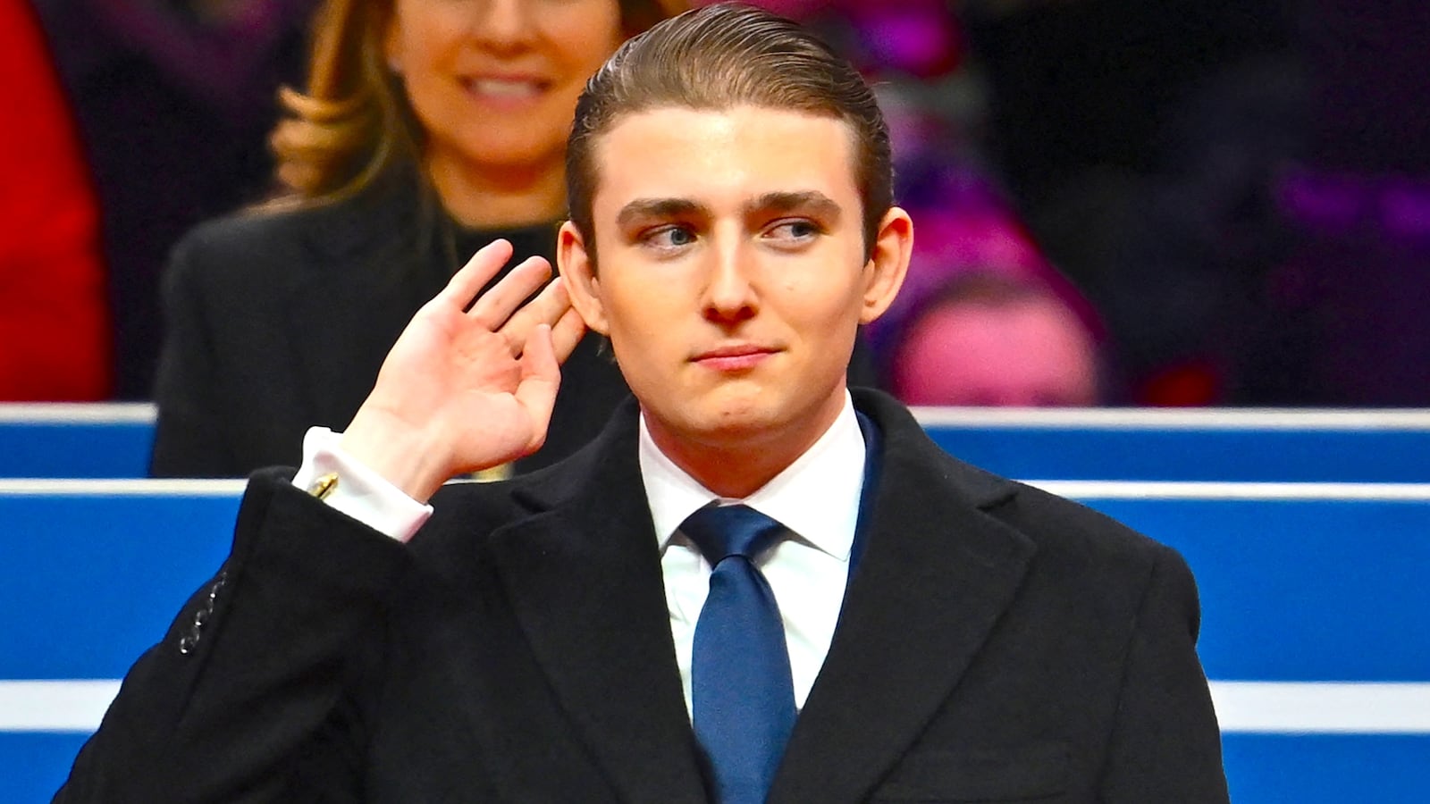 Barron Trump gestures after being acknowledged by his father US President Donald Trump during the inaugural parade inside Capital One Arena, in Washington, DC, on January 20, 2025.