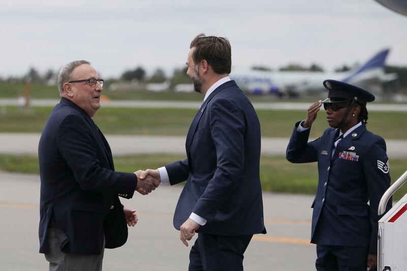 U.S. Vice President JD Vance shakes hands with Former Maine Gov. Paul LePage, as the Vice President arrives in Bangor, Maine, U.S., May 14, 2026. REUTERS/Taylor Coester