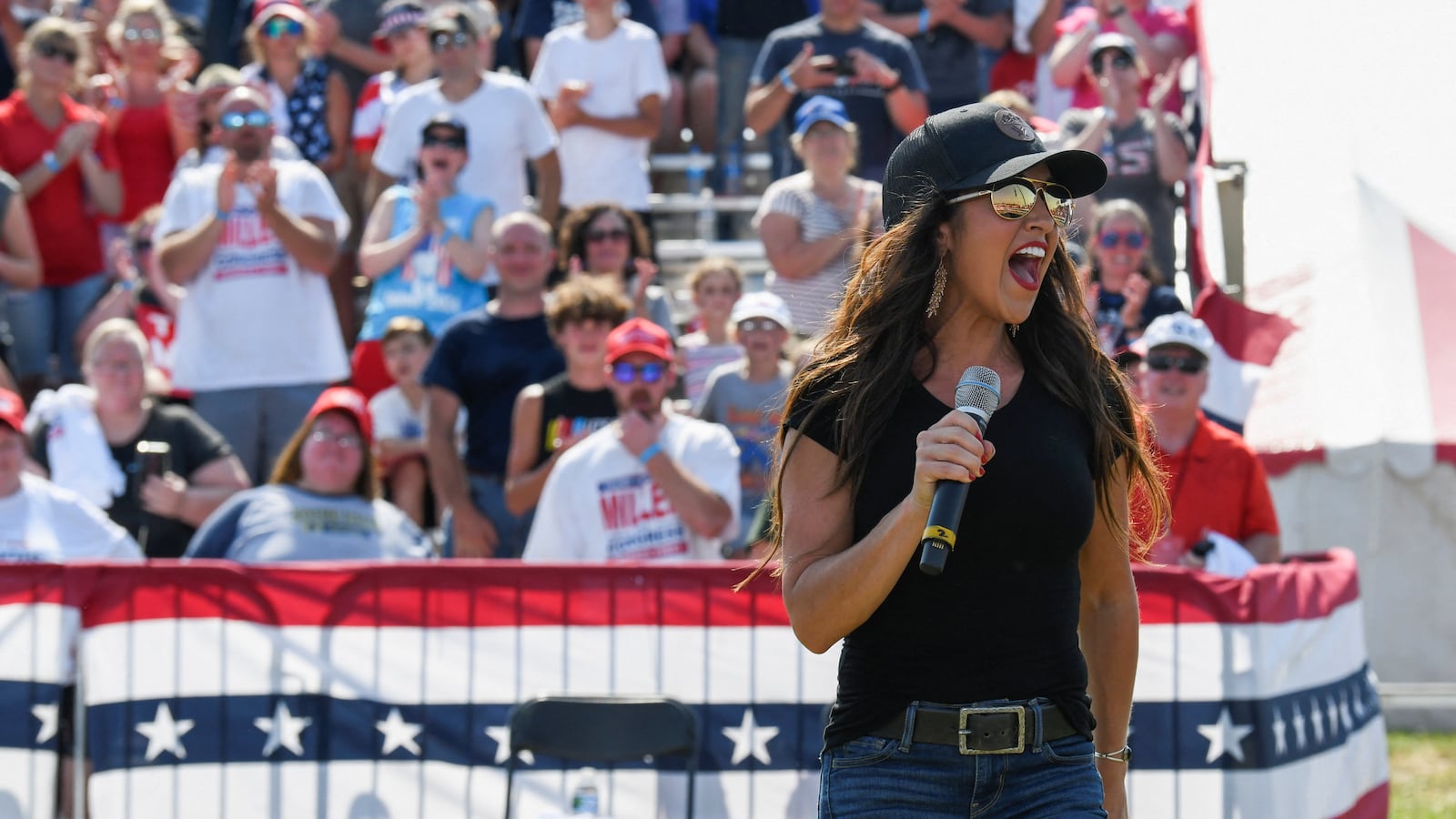 Lauren Boebert speaking into a microphone at a Save America Rally in Illinois.