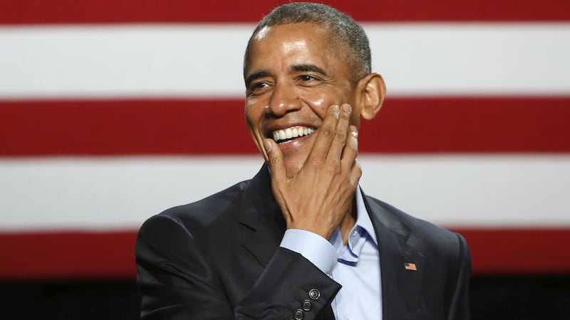 U.S. President Barack Obama laughs while joking about Republican presidential candidate Donald Trump's personal brand of wine as he delivers remarks to supporters at a Democratic National Committee (DNC) event at Gilley's Club in Dallas, Texas March 12, 2016.