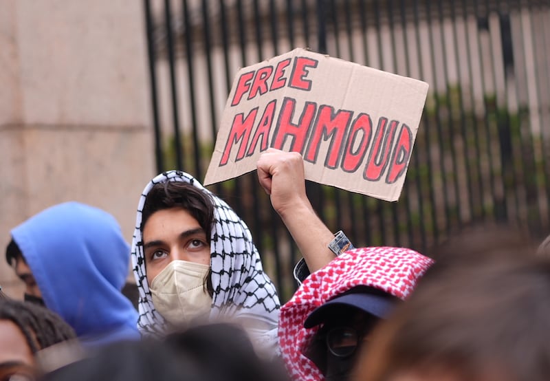 NEW YORK, UNITED STATES - APRIL 02: A protester holds a cardboard sign reading "Free Mahmoud" as Jewish students chain themselves to the gates of Columbia University, demanding accountability from the university's trustees following the arrest of Mahmoud Khalil, in New York, United States on April 2, 2025. (Photo by Selcuk Acar/Anadolu via Getty Images)