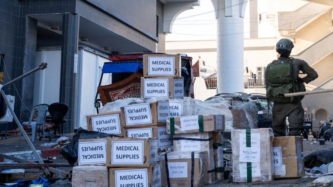 Israeli soldier stands near boxes labelled Medical Supplies at the Al Shifa hospital complex.