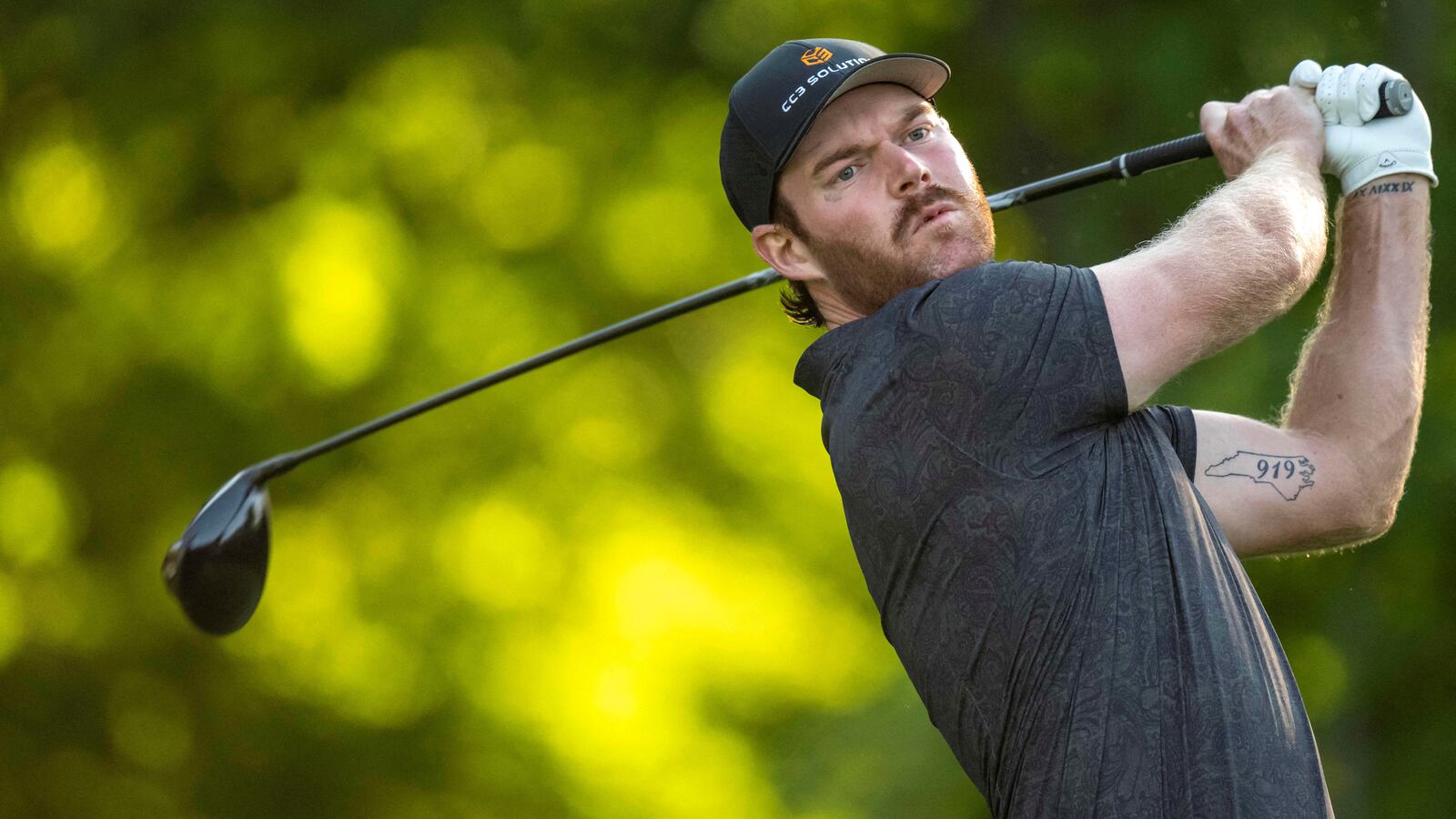 Grayson Murray follows through on a golf swing.