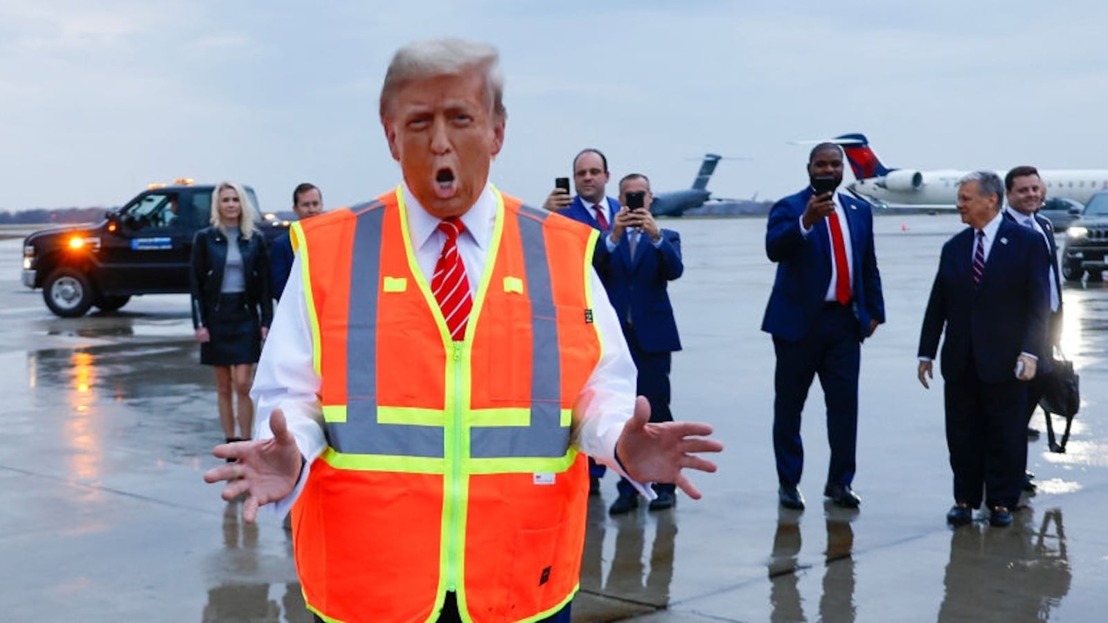 Donald Trump dresses in a garbage company’s high-visibility vest and speaks to the media at Green Bay Austin Straubel International Airport in Wisconsin.