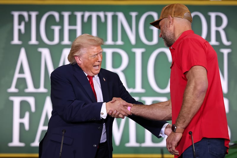 U.S. President Donald Trump shakes hands with Hall of Fame Farms owner Joe Thomas (R) as he arrives to a roundtable on agriculture at Custer Farms on June 05, 2026 in Chippewa Falls, Wisconsin.