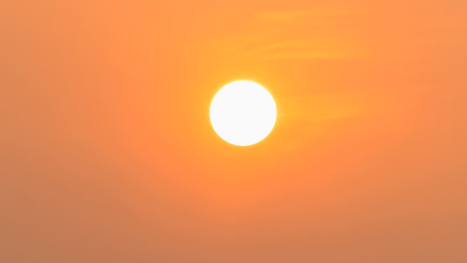 The sun in the sky on a hot day.