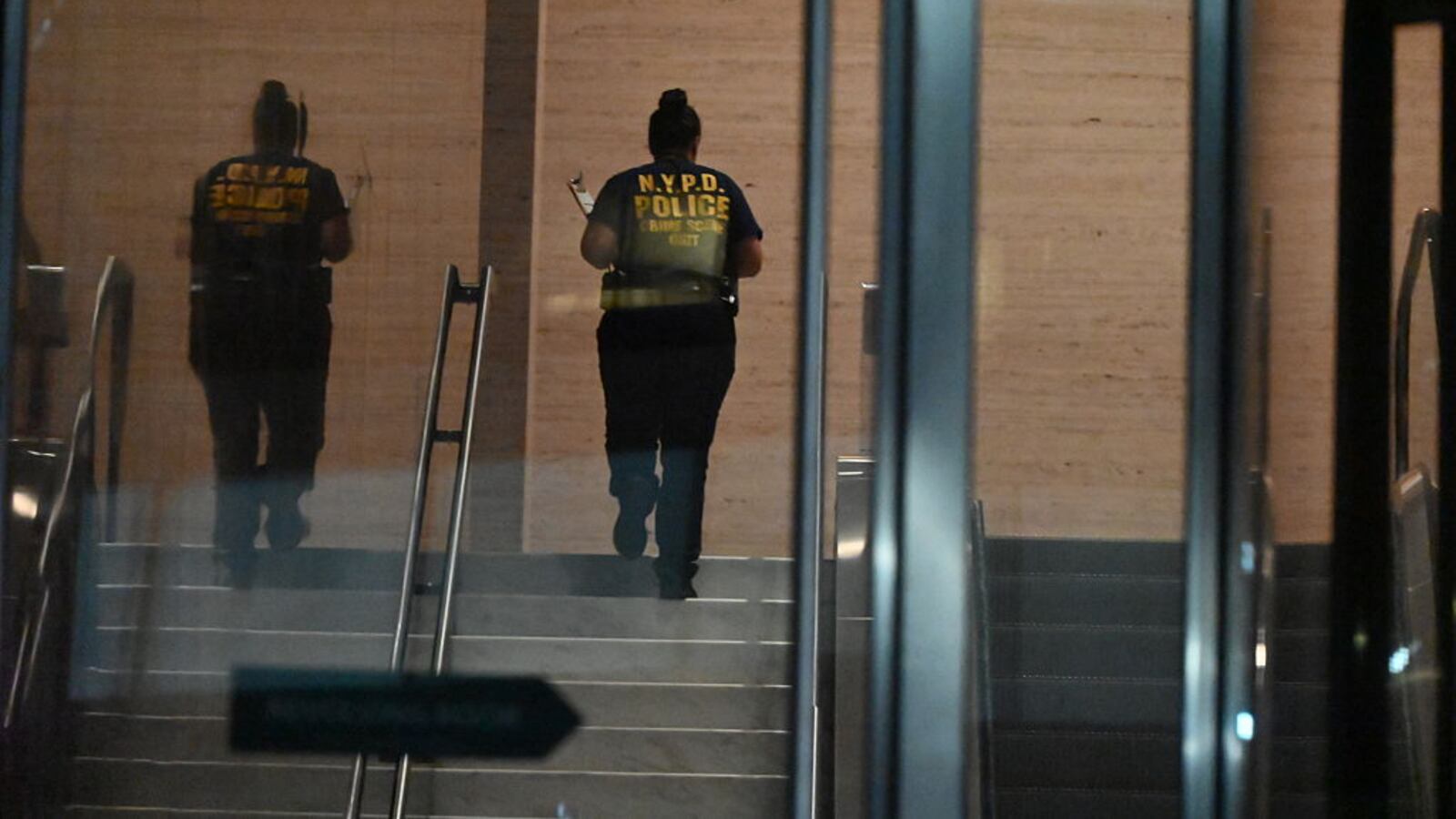 Members of the New York City Police Department Crime Scene Unit work at the scene and enter the building with evidence bags to collect evidence where five people were shot with four people including NYPD police officer Didarul Islam killed in a mass shooting attack at 345 Park Avenue by suspect Shane Tamura armed with an assault rifle in New York City, United States on July 28, 2025.