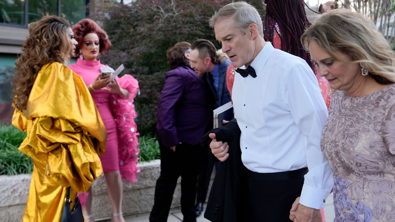 Rep. Jim Jordan, R-Ohio, and Polly Jordan walk past Tara Hoot, Ricky Rosé, Vagenesis and Maria Con Carne outside the Kennedy Center, to attend Les Miserables, Wednesday, June 11, 2025, in Washington, on the night that President Donald Trump and first lady Melania Trump were also attending.