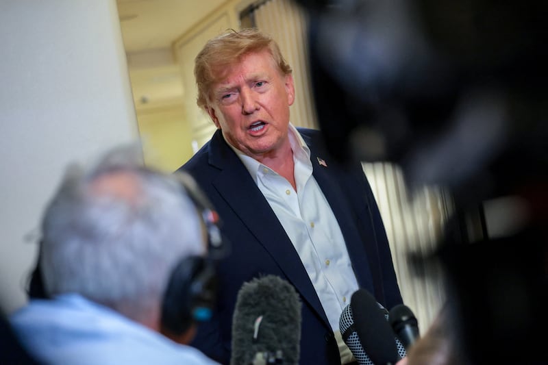 U.S. President Donald Trump speaks to members of the media aboard Air Force One, en route to Joint Base Andrews, Maryland, U.S., following a two-day visit to Ireland, September 13, 2026.