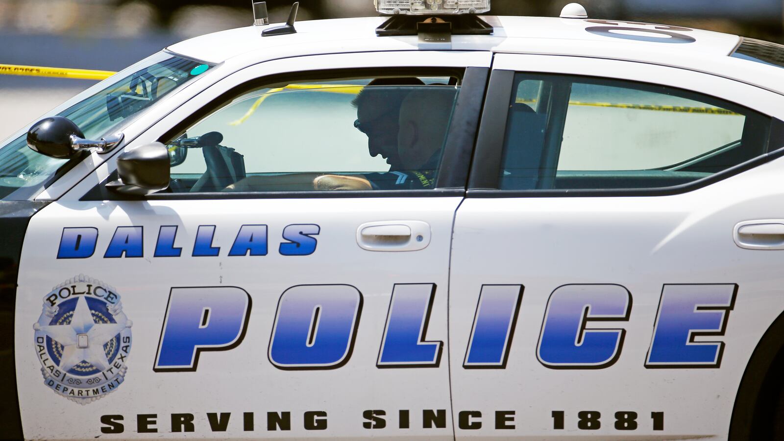 Police officers talk in a squad car in Dallas, Texas