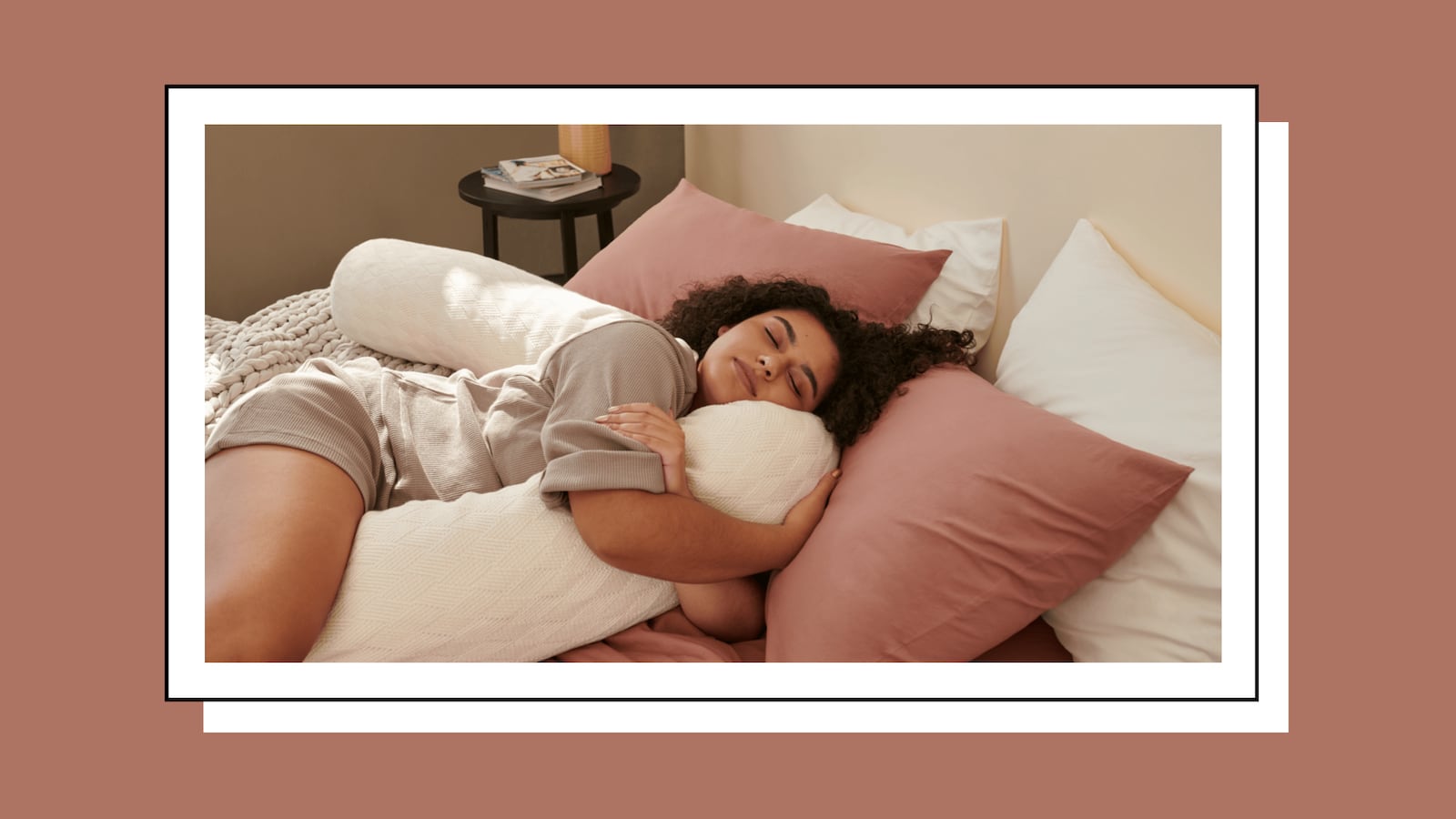 Woman hugging Bearaby's Cuddler body pillow