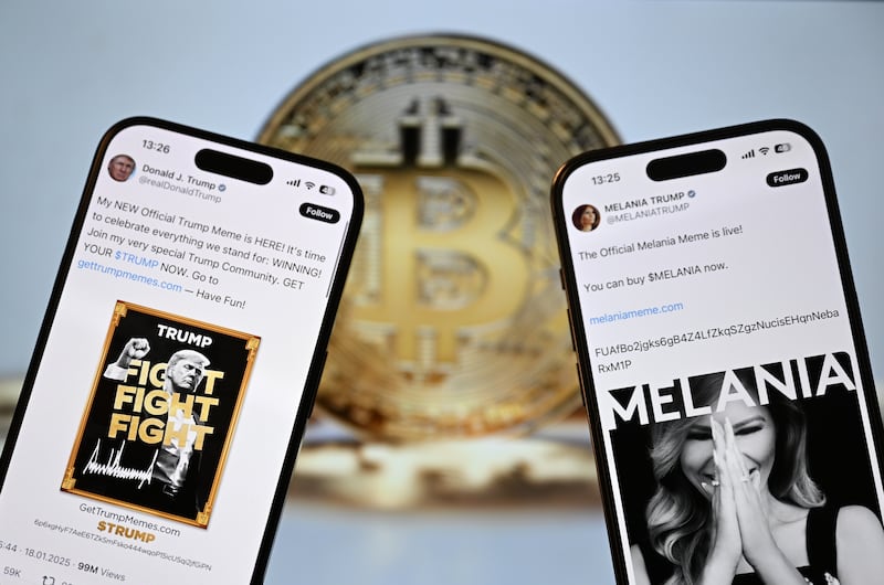 ANKARA, TURKIYE - JANUARY 21: US President Donald Trump's and US first lady Melania Trump's X accounts promoting the new meme caoins $TRUMP and $MELANIA coins are seen on a mobile phone screen in front of Bitcoin's logo in Ankara, Turkiye on January 21, 2025. (Photo by Hakan Nural/Anadolu via Getty Images)