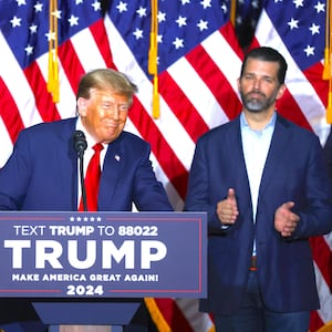 Donald Trump speaks as Donald Trump Jr. looks on, at the Iowa Events Center on January 15, 2024 in Des Moines, Iowa.