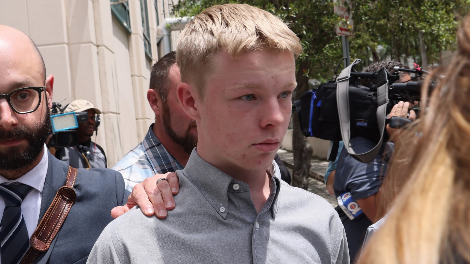 Timothy Hudson, 16, leaves the James Lawrence King Federal Justice Building.