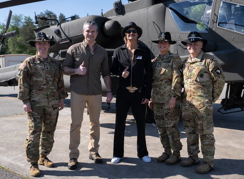 Kid Rock and Pete Hegseth with members of the military.