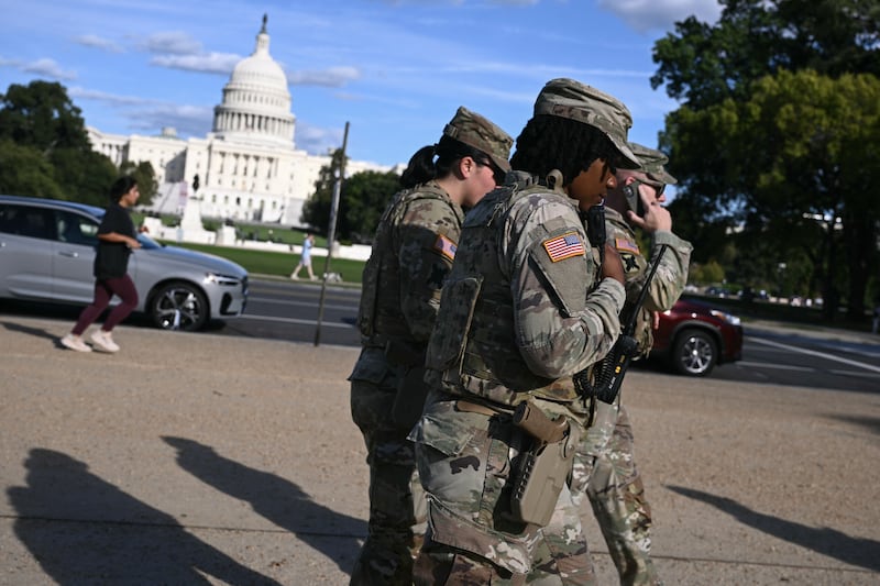 Members of the National Guard patrol along the National Mall near the US Capitol on the second day of the US government shutdown in Washington, DC, on October 2, 2025. Efforts to swiftly end the US government shutdown collapsed October 1, 2025 as Democrats in Congress went home without resolving an acrimonious funding stand-off with President Donald Trump and the White House threatened public sector jobs.