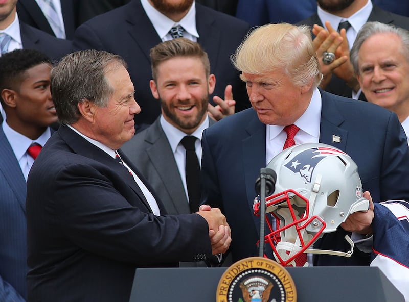 WASHINGTON D.C. - APRIL 19: President Donald Trump shakes hands with New England Patriots head coach Bill Belichick, left, as Patriots player Julian Edelman looks on at center during a ceremony at the White House in Washington D.C. on Apr. 19, 2017. (Photo by John Tlumacki/The Boston Globe via Getty Images)