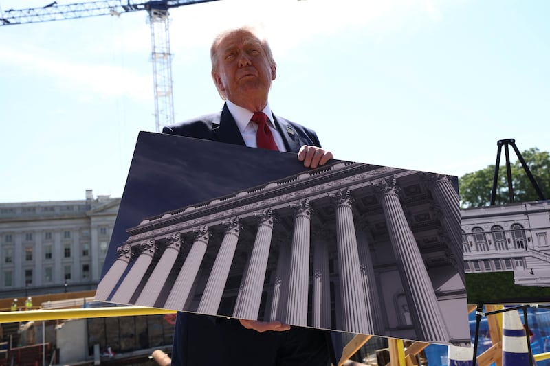 U..S. President Donald Trump shows an image of the concept at the site of ongoing construction of the planned White House ballroom in Washington, D.C.