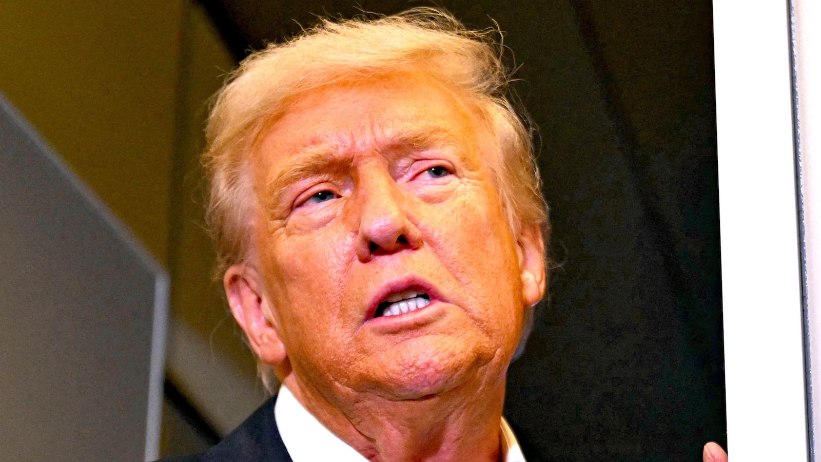 US President Donald Trump speaks with the press on board Air Force One