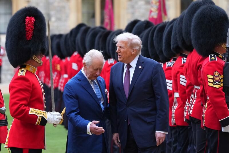 WINDSOR, ENGLAND - SEPTEMBER 17: US President Donald Trump (R) and King Charles III (C) review the Guard of Honour after their arrival at Windsor Castle on day two of the US President Donald Trump's second state visit to the UK on September 17, 2025 in Windsor, England. (Photo by Kirsty Wigglesworth - WPA Pool/Getty Images)