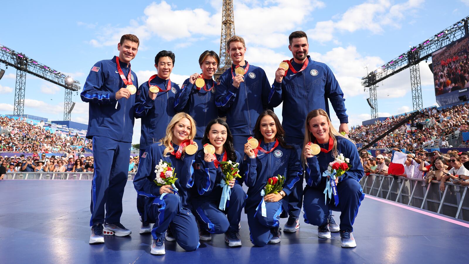 Members of the U.S. Olympic figure skating team pose for a photo after receiving gold medals.