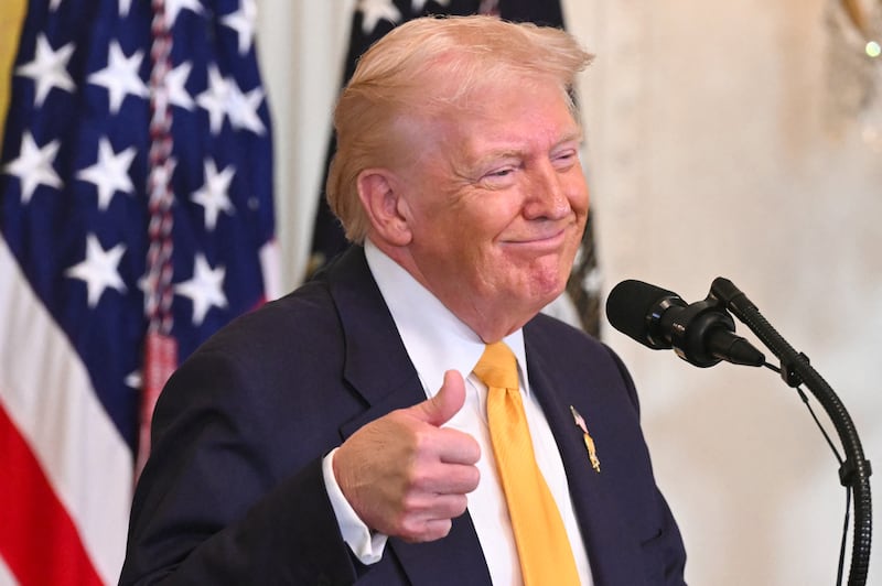 US President Donald Trump gives a thumbs up as he speaks during a Black History Month event in the East Room of the White House in Washington, DC, on February 18, 2026. (Photo by SAUL LOEB / AFP via Getty Images)