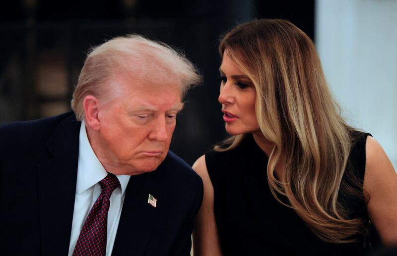 U.S. first lady Melania Trump relays a reporter's question to President Donald Trump during a private dinner for technology and business leaders in the State Dining Room at the White House in Washington, D.C., U.S., September 4, 2025.  REUTERS/Brian Snyder
