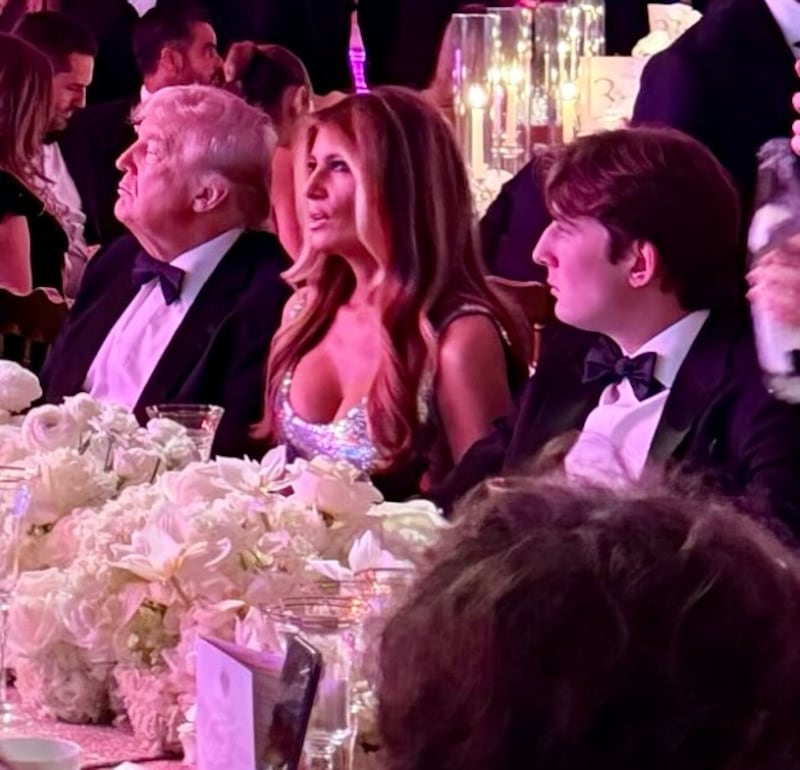 Donald and Melania Trump, with their son Barron (R), at the New Year's party at Mar-a-Lago.